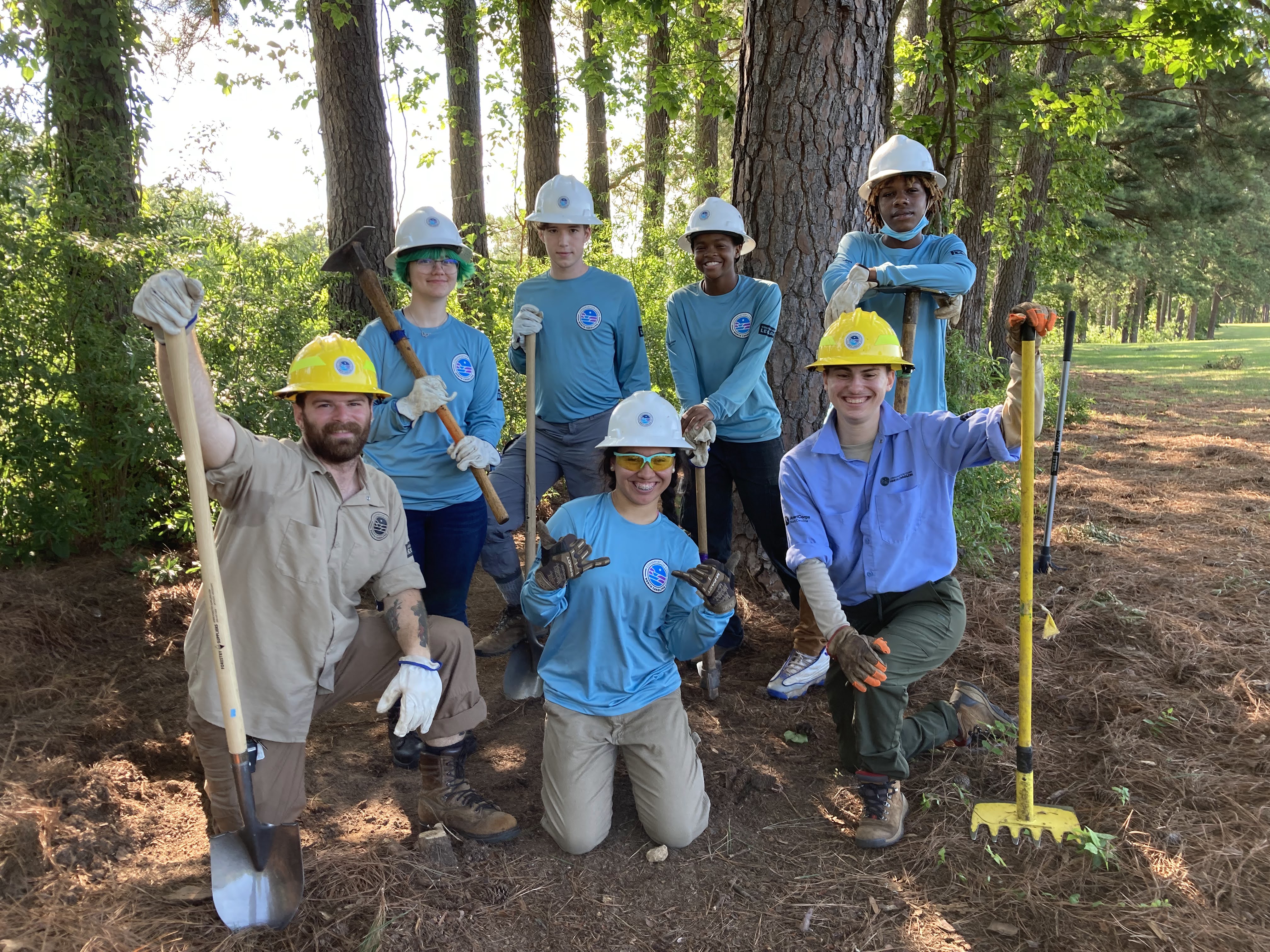 Crew members from CCNC Dix Park Youth Crew 2022 posing in front of the trail they helped build