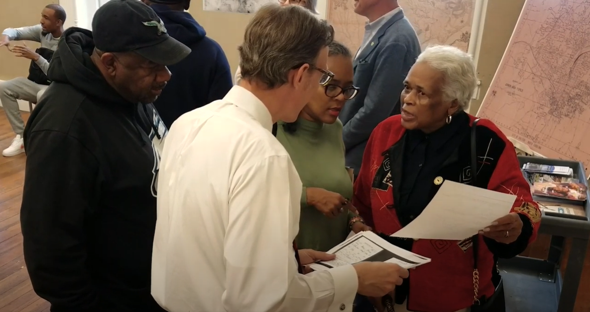 Hunter family members discuss research documents with Ernie Dollar of the COR Museum