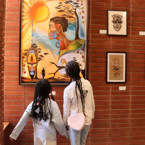 Two girls viewing art in the 2025 Living In Color Exhibit