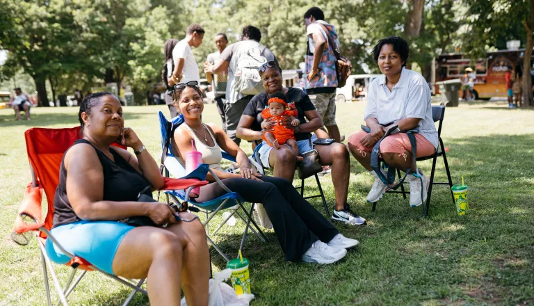 Group of people outside in lawn chairs