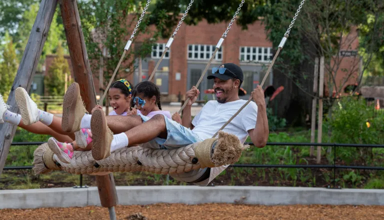 Gipson Play Plaza family on the swing terrace 