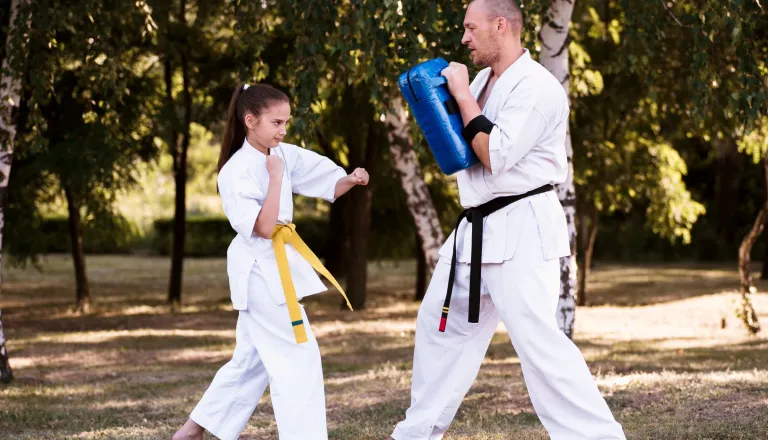Parent and child taekwondo outdoors