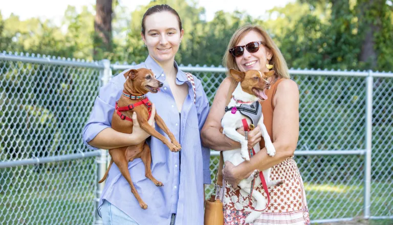 Two women with their dogs at the Dix Park Dog Park Yappy Hour event 2022