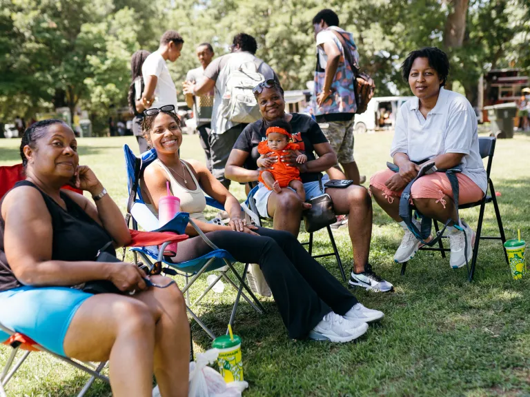 Group of people outside in lawn chairs