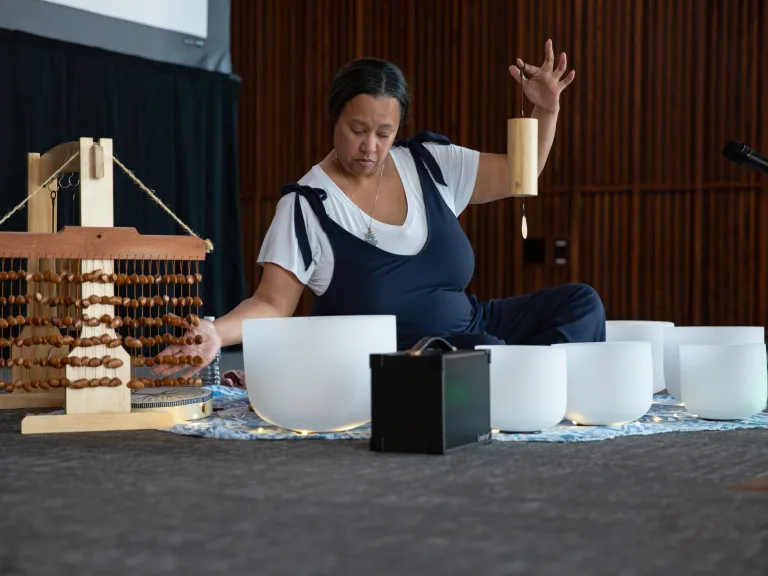 Woman performing sound bath