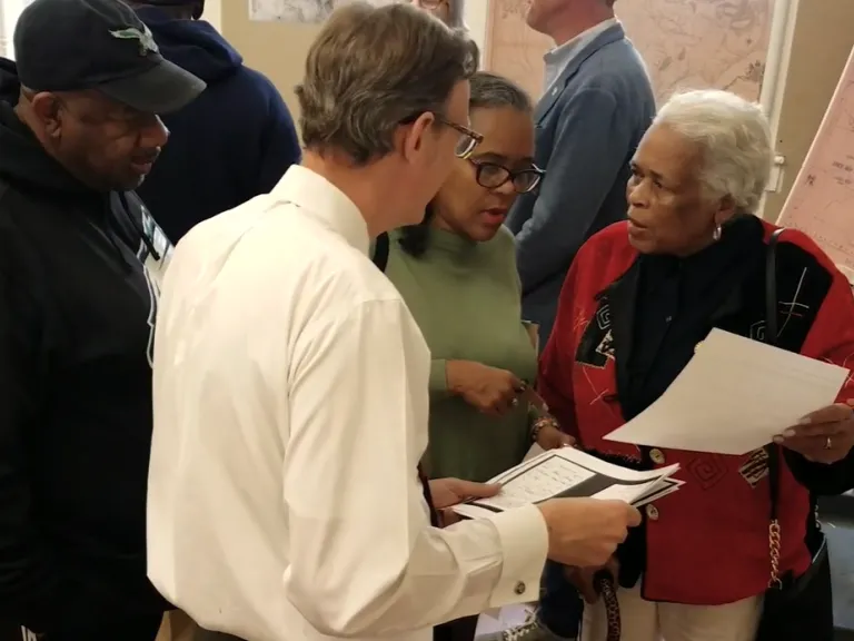 Hunter family members discuss research documents with Ernie Dollar of the COR Museum