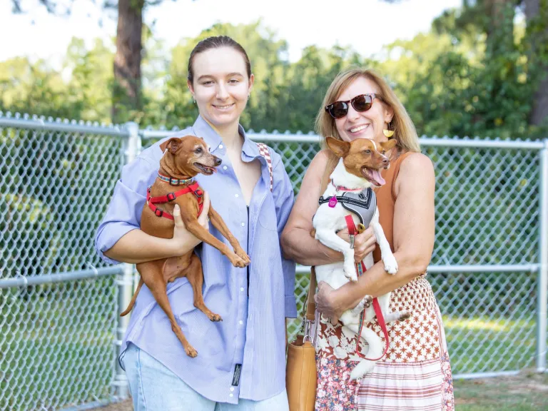 Two women with their dogs at the Dix Park Dog Park Yappy Hour event 2022
