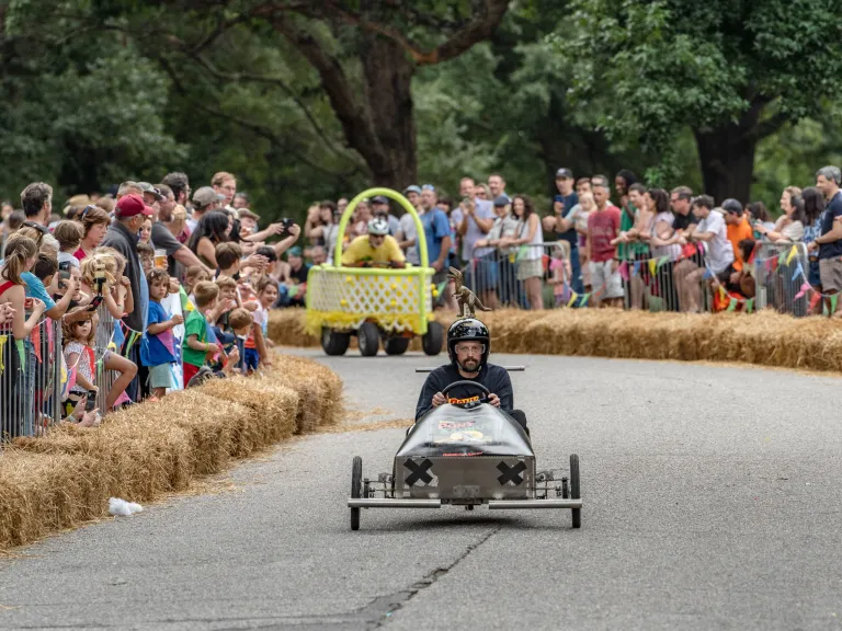 Two soapbox carts racing at Dix Park during Kirby Derby 2025