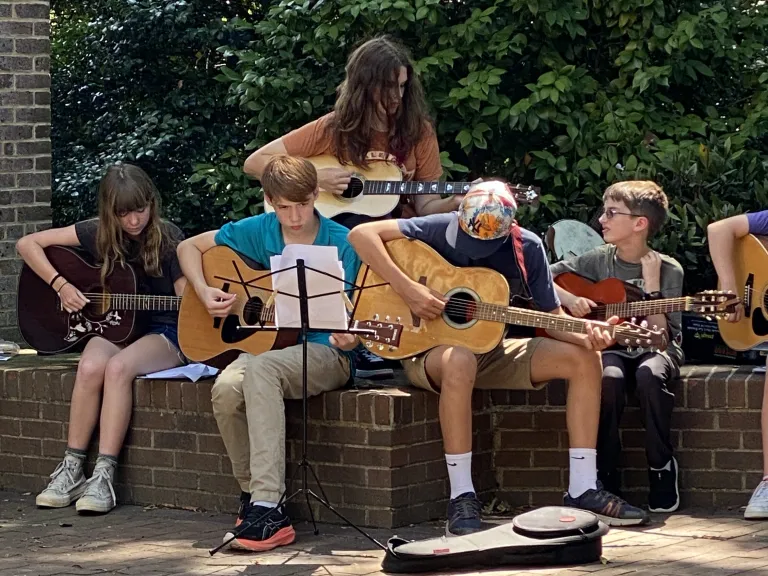 young adults playing guitars