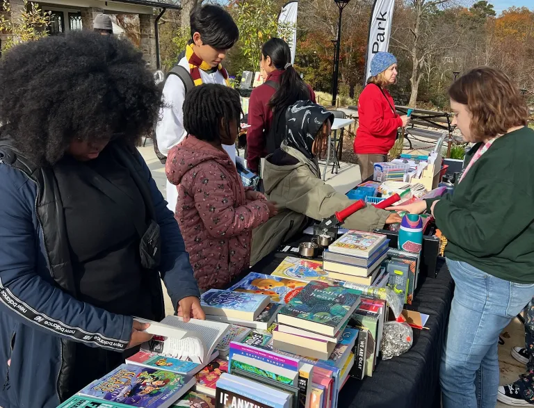 Young adults outside with books