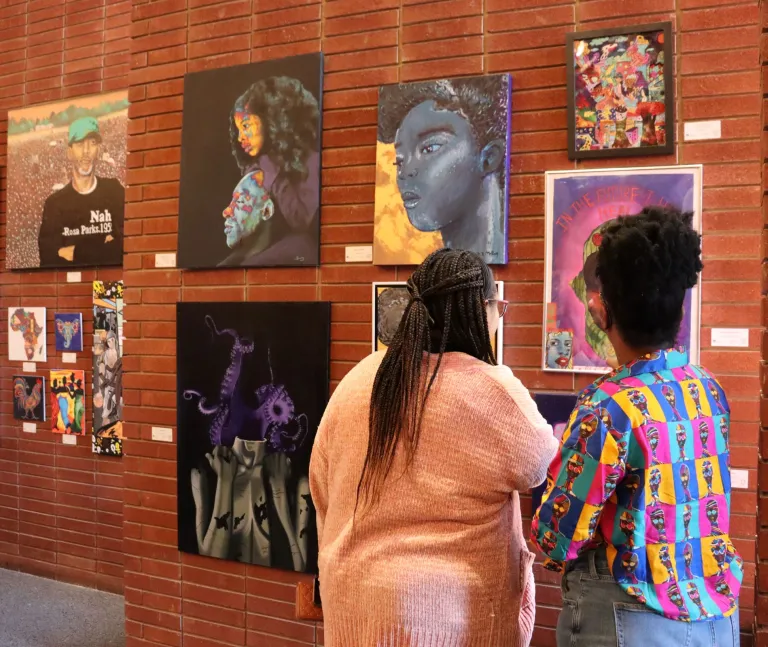 People visiting the 2024 Living In Color exhibit in the Chapel